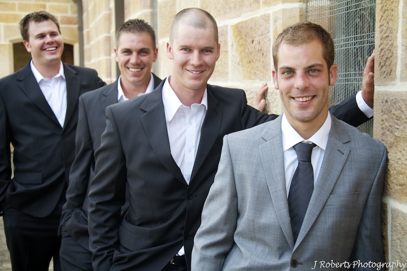 Grooms men leaning on church wall - wedding photography sydney